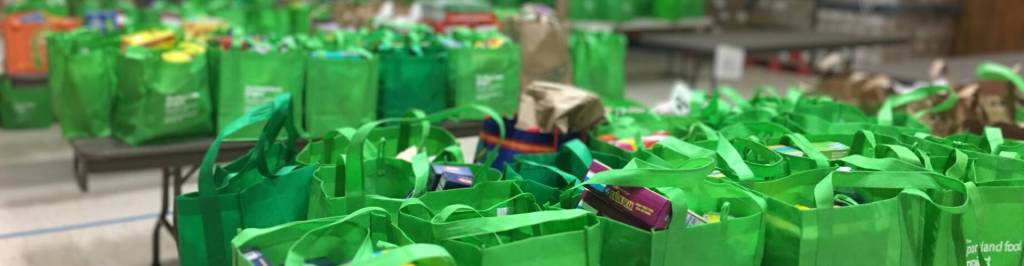 Assembled food donation bags on tables, ready for delivery
